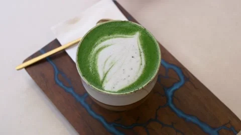 Decaffeinated green matcha coffee served stylish coffee shop on beautiful wooden Stock Footage 221411458