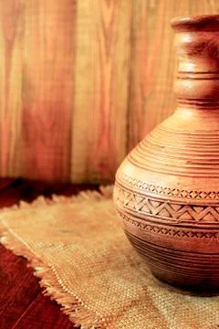 Decanter ceramic brown on the sacking. Old crockery Stock Photos