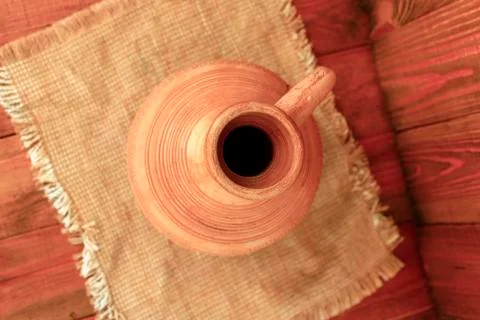 Decanter ceramic brown on the sacking. Old crockery. Top view Stock Photos