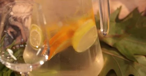 A decanter with lemonade on the table, which is served in autumn style on t.. Stock Photos