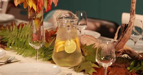 A decanter with lemonade on the table, which is served in autumn style on t.. Stock Photos