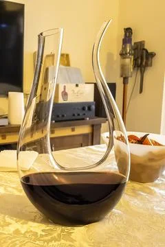 A decanter of red wine stands on the table. Wine. Stock Photos
