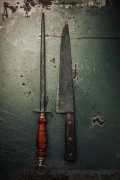 Decayed metallic texture with set of old knife sharpener and knife Photos