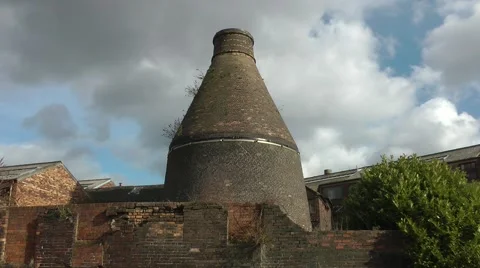 Decaying old conical bottle kiln red brick skyline Stock Footage 47407891