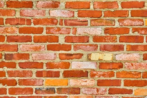 Decaying red brick wall with textured white bricks background asset 스톡 사진