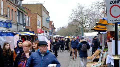 December 2018: St Albans Charter market is busy with shoppers on a cold weekend Stock Footage