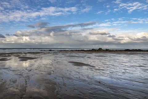 December blue sky with dappled clouds on Cornish beach Stock-Fotos
