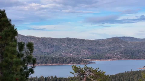 Decend down into forest with lake and mountains in background Stock Footage 329903183