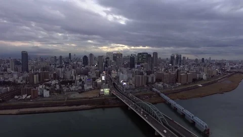 Decending view of Osaka city night lights aerial Umeda Stock Footage 73663371