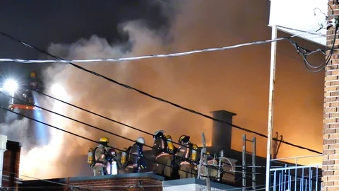 Decent flames and firefighters Stock Footage 115936405