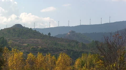 Deciduous trees and windmill power generators on mountain Stock Footage 49964282