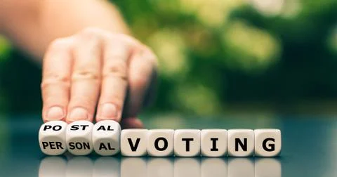 Decision for postal voting. Hand turns dice and changes the expression "perso Stock Photos