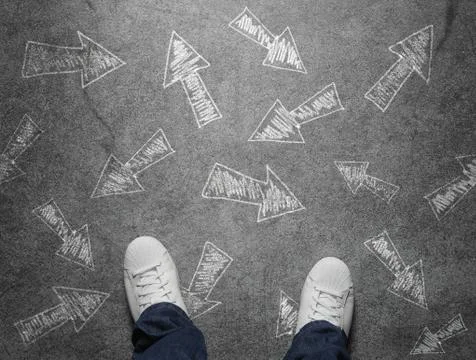 Decisions, high angle view of many arrows pointed in different directions Stock Photos