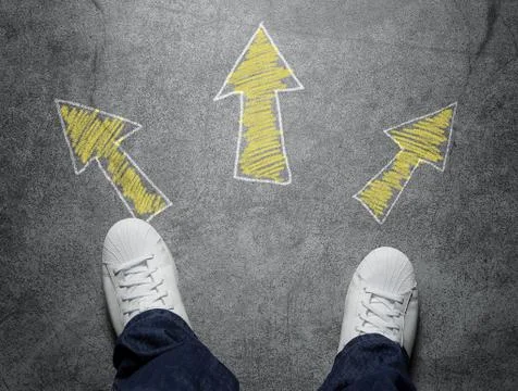 Decisions, high angle view of three arrows pointed in different directions Stock Photos