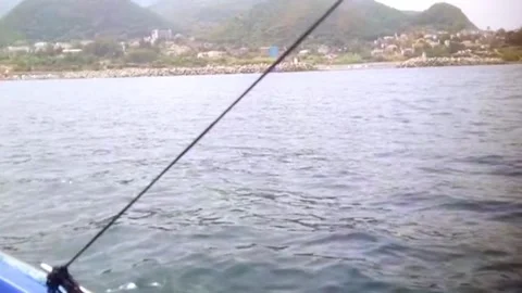 The deck of a boat looking out over a relatively calm body of water. Stock Footage 320408652