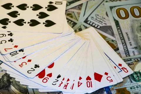 Deck of cards on the background of dollar bills Photos