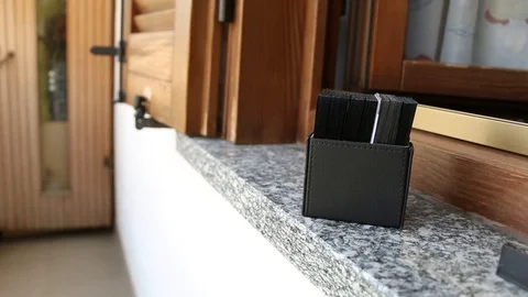 Deck of cards with black sleeves sitting on a window Stock Footage 93283036