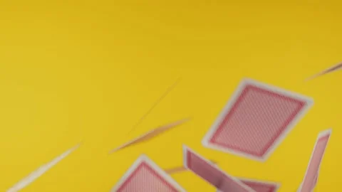 The deck of cards explodes in 4k UHD. Yellow background Stock Footage 145265363