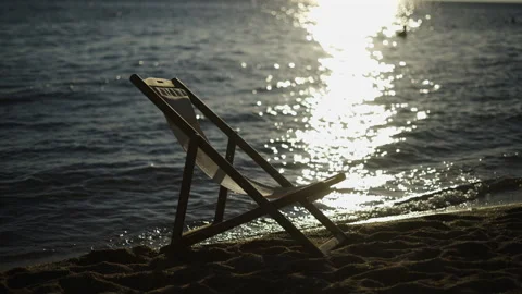 Deck chair at the beach Stockbeeldmateriaal 213097964