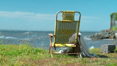 Deck chair mockup on a grass beach with blue sea background, rear view Stock Footage 345625238