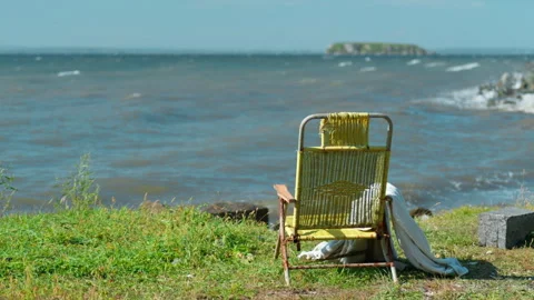 Deck chair mockup on a grass beach with blue sea background, rear view Stock-Footage 345625289