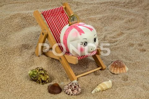 Deck chair with piggy bank and euro Stock Photos