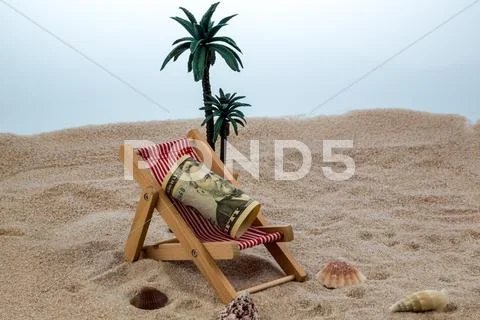 Deck chair with piggy bank and dollars Stock Photos