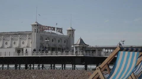 Deck Chairs on Beach in front of Brighton Pier | HD 1080 Stock Footage 47717622