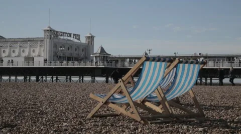 Deck Chairs on Beach in front of Brighton Pier | HD 1080 Stock Footage 47717705