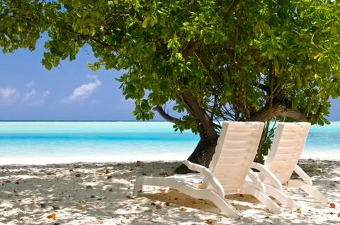 Deck chairs at the beach Stock Photos