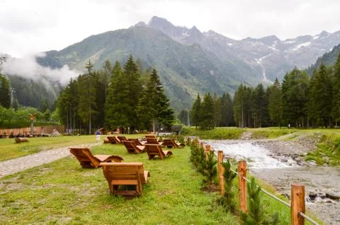 Deck chairs lined up facing the mountain Stock Photos