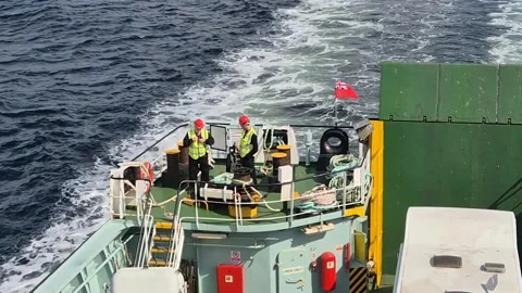 Deck hands on the CalMac ferry, MV Bute as it approaches Rothesay, Isle of Bute Stock Footage 314910582