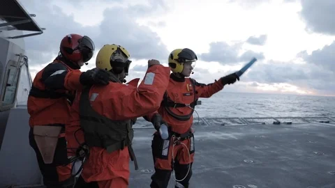 Deck hands secure Super Lynx and practice escorting a passenger - 2018 Stock Footage 106143028