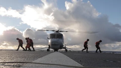 Deck hands secure Super Lynx and practice escorting a passenger - 2018 Stock Footage 106143105