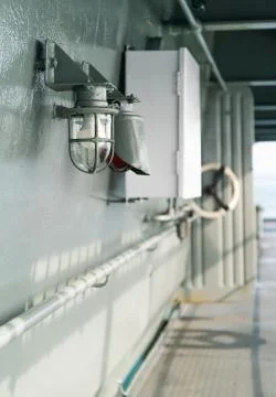 Deck lamp on ship in protective cage Stock Photos