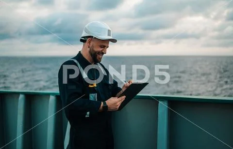 Deck Officer on deck of offshore vessel or ship , wearing PPE personal ...