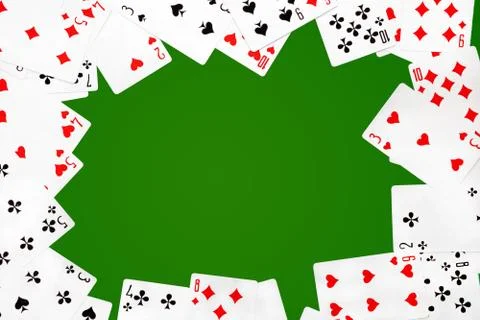 Deck of playing cards on green background poker table with copy space in the Stock Photos