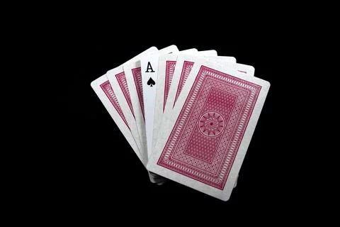 Deck of playing cards with red backside isolated on black background Stock Photos