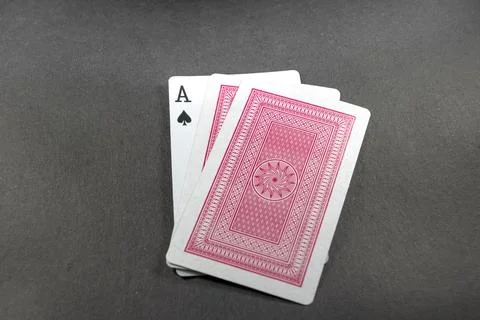 Deck of playing cards with red backside isolated on black background Stock Photos