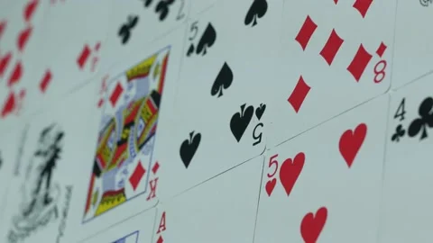 Deck of playing cards is spread out on a table in a casino Stock Footage 89544320