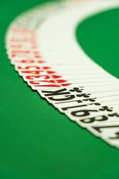 Deck of playing cards spread out on the felt Stock Photos