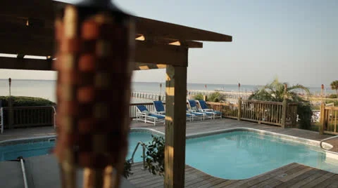 Deck pool with unfocused tiki lamp in view Stock Footage 26138203