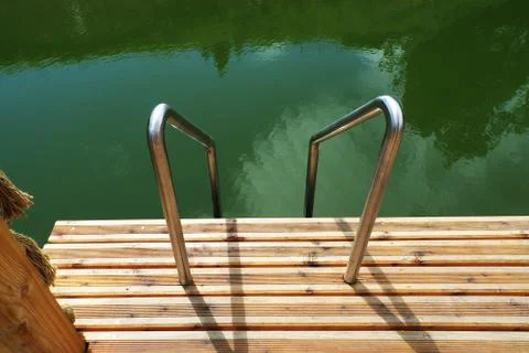 Deck on swimming pool Stock Photos