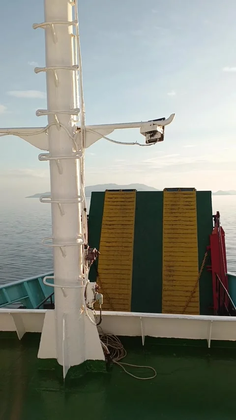 Deck view of a ferry sailing between islands during sunset Stock Footage 280986465