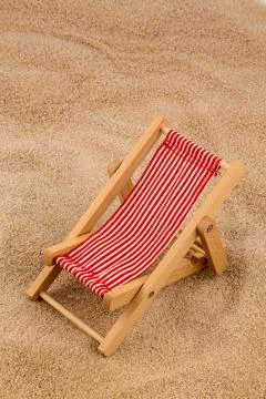 Deckchair on a sandy beach Stock Photos