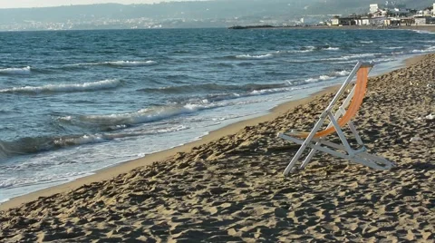 Deckchairs abandoned on the seashore Stock Footage 65440169