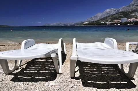 Deckchairs on a beach Stock Photos
