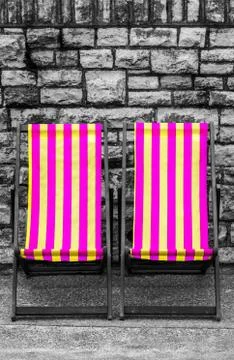 Deckchairs in seaside town Stock Photos