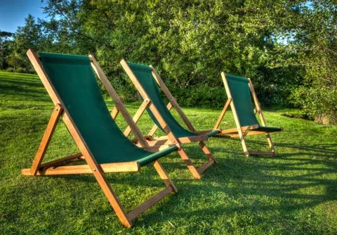 Deckchairs at sunset Stock Photos