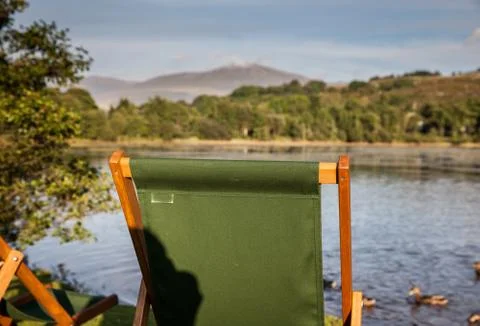Deckchairs at sunset Stock Photos